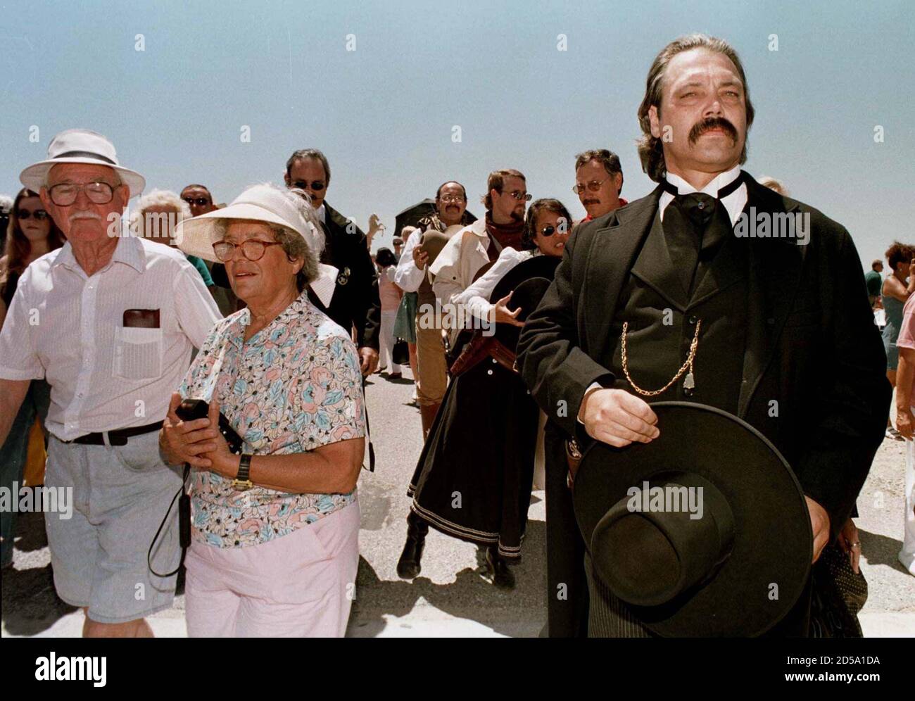 Fans leave the Roy Rogers and Dale Evans Museum, including a member of the  honor guard dressed in western costume, after a hearse containg Rogers'  remains circled the parking lot July 11