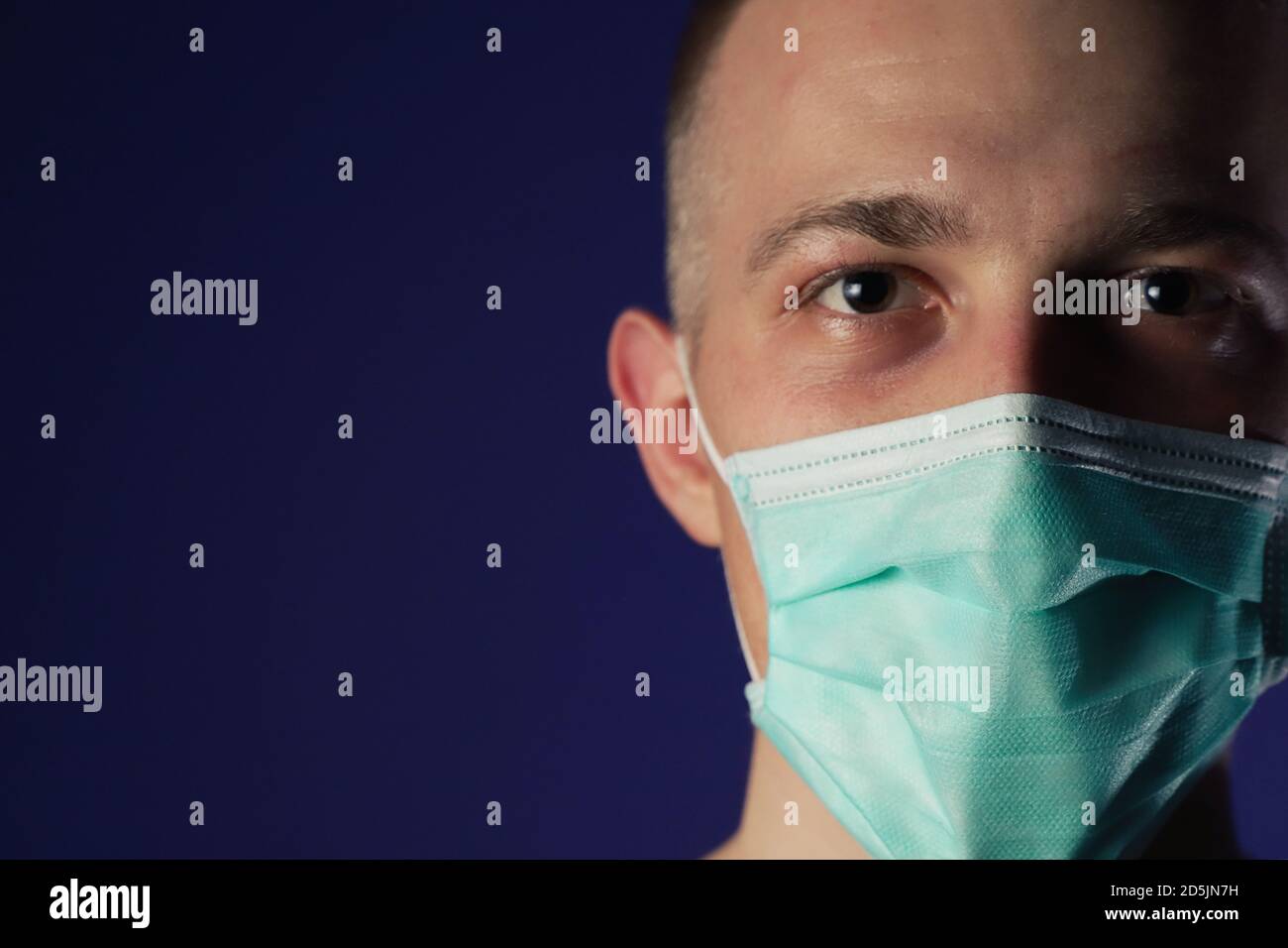 Uomo malato caucasico in maschera medica gause con palmo sulla testa Foto Stock