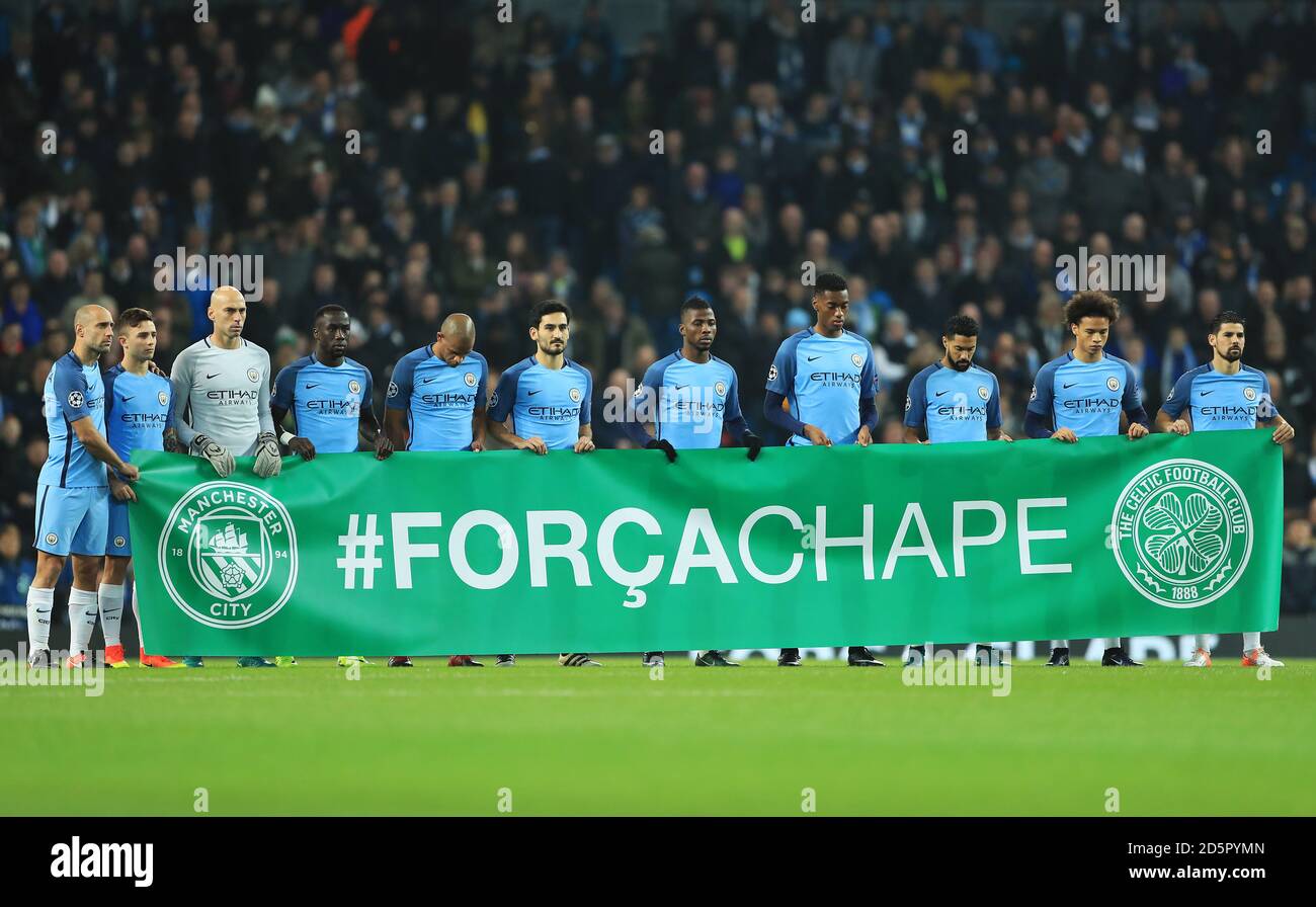 I giocatori di Manchester City si levano in piedi per un minuto di silenzio prima del gioca e tieni una bandiera in omaggio ai membri Di Chapecoense Football Club ucciso in un incidente aereo Foto Stock