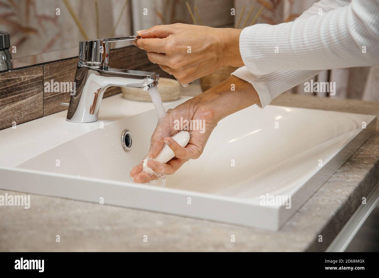 lavarsi accuratamente mani e dita con sapone sotto l'acqua corrente, uccidendo tutti i virus e i batteri, prevenendone la diffusione Foto Stock