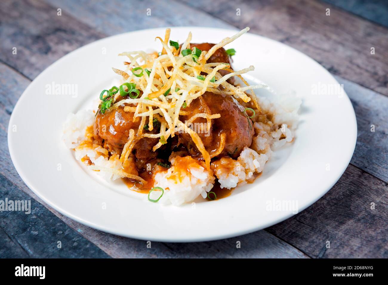 Polpette di manzo fresche servite con una salsa su un letto di riso Foto Stock