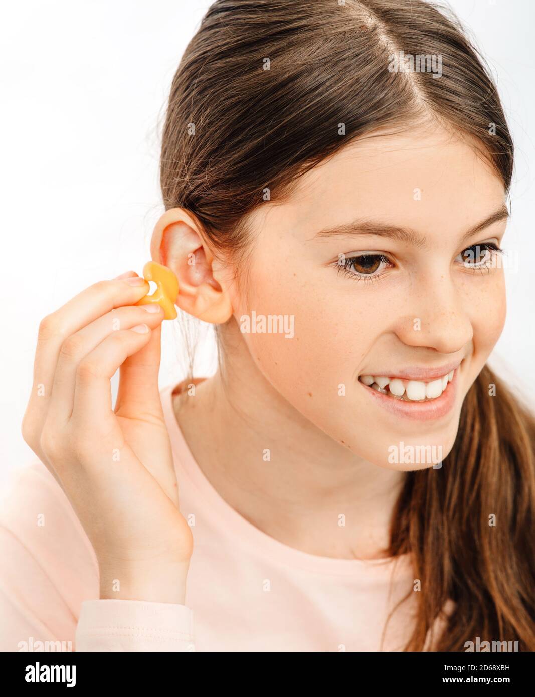 Tappi auricolari individuali per bambini. Ragazza che tiene singoli tappi per le orecchie vicino all'orecchio, primo piano Foto Stock