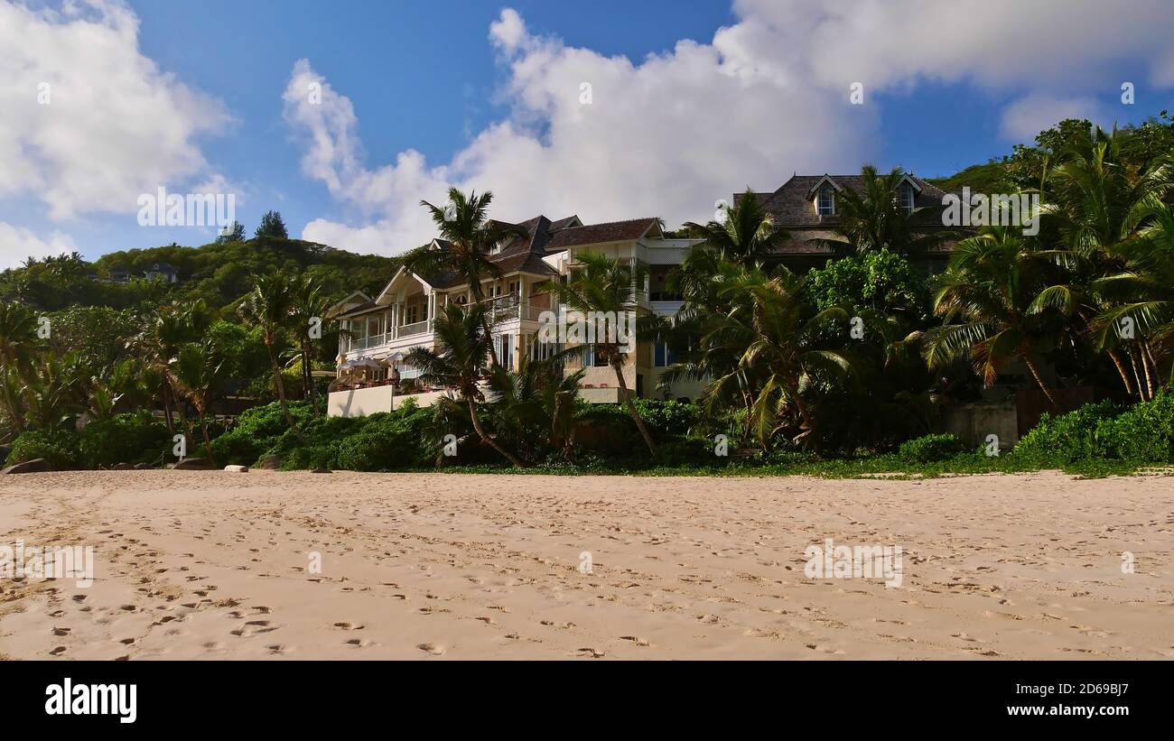 Anse Intendance, Mahe, Seychelles - 10/03/2018: Resort di vacanza di lusso 'Banyan Tree' (popolare per la luna di miele) con palme da cocco sulla spiaggia pubblica. Foto Stock