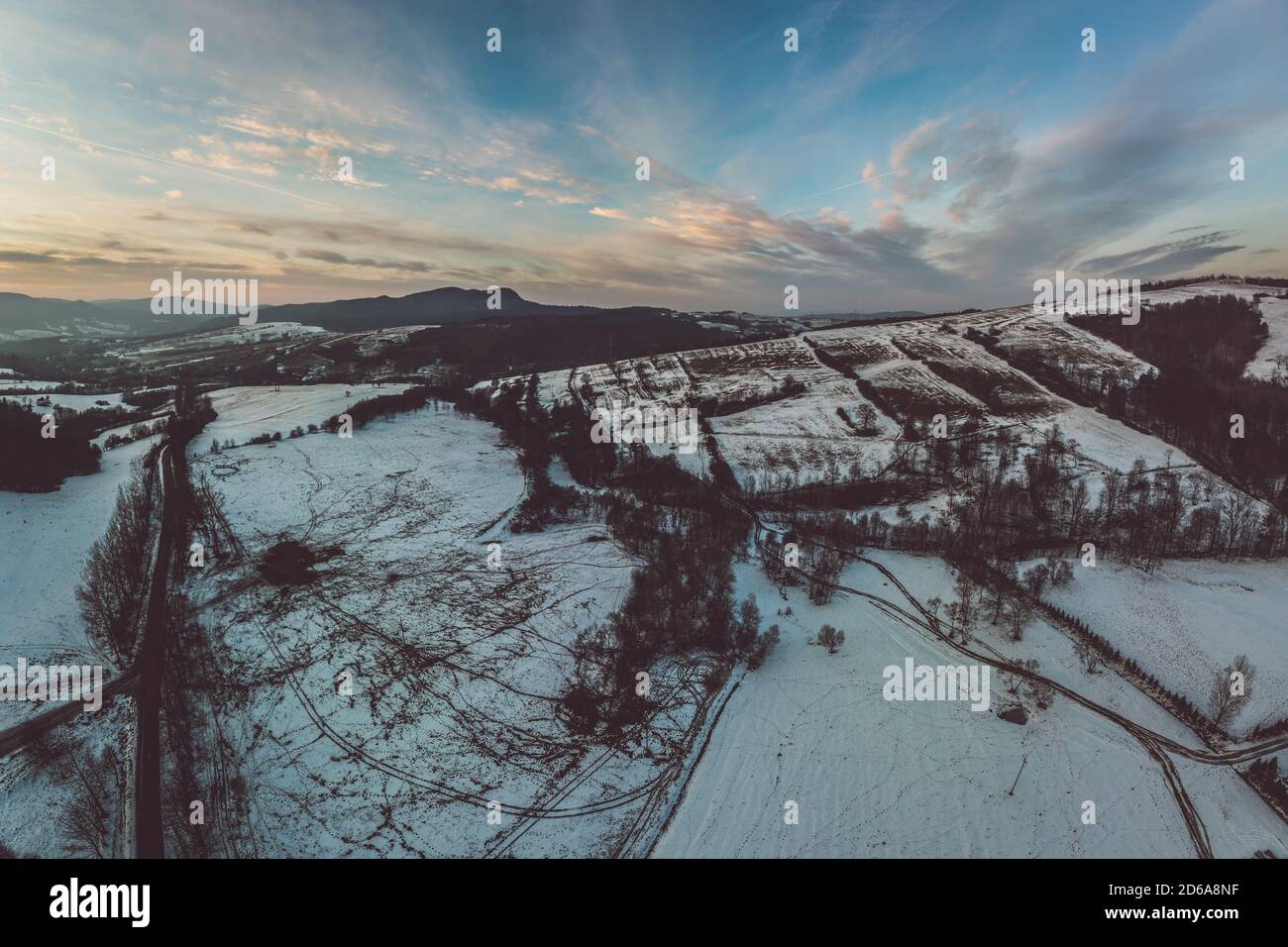 Beskid inferiore, Carpazi catena montuosa in inverno vista aerea, arancione e cielo rosa Foto Stock