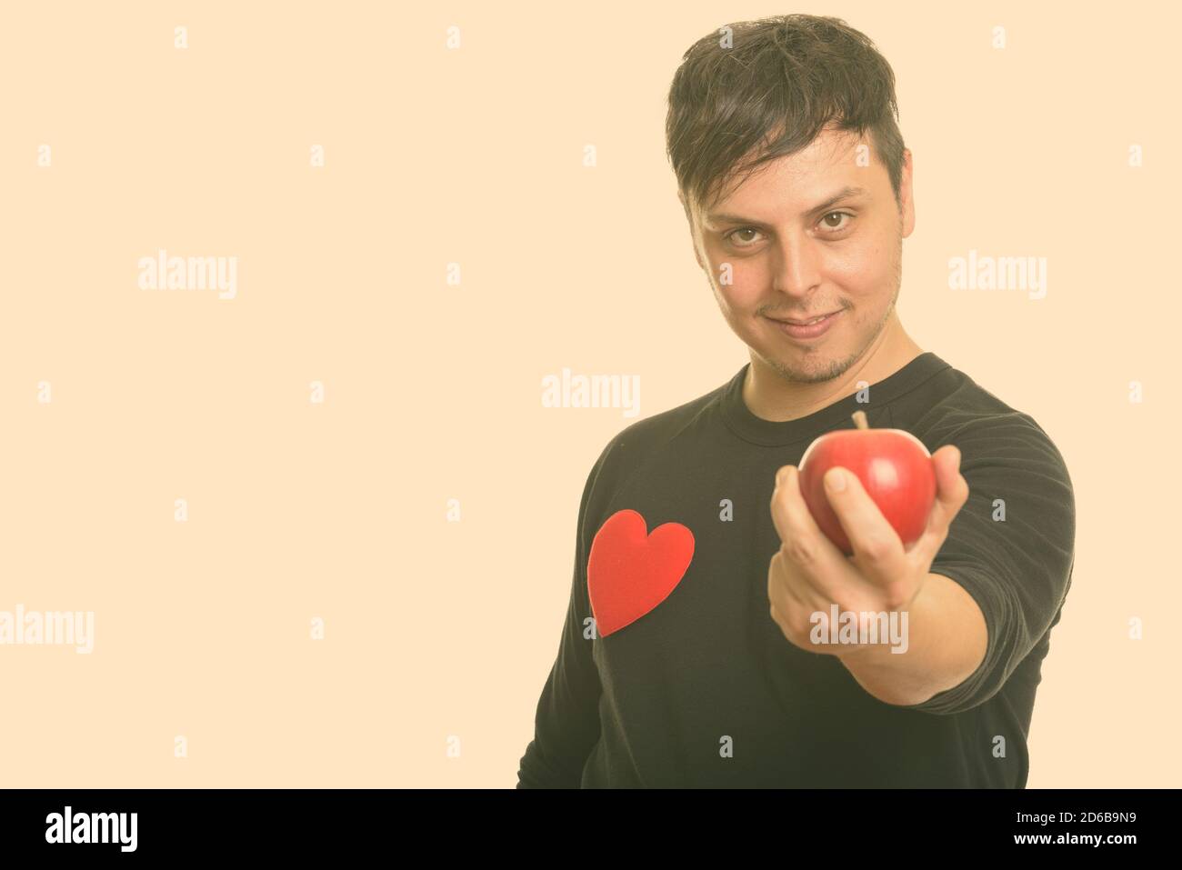 Studio girato di pazzo uomo caucasico dando mela rossa pronto Per San Valentino Foto Stock