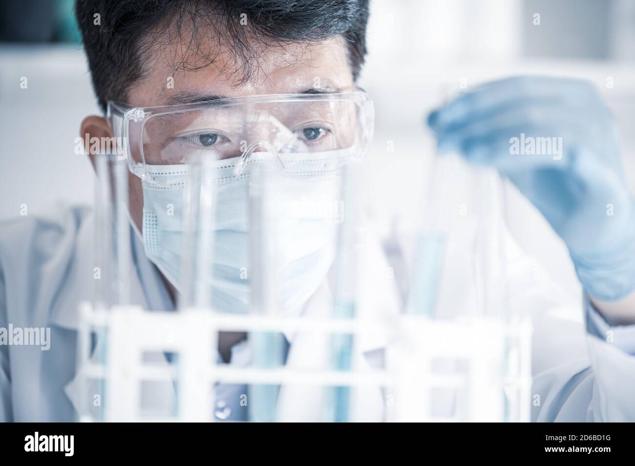 Scienziato maschile asiatico che lavora in un laboratorio. Concetto di sviluppo del vaccino. Foto Stock