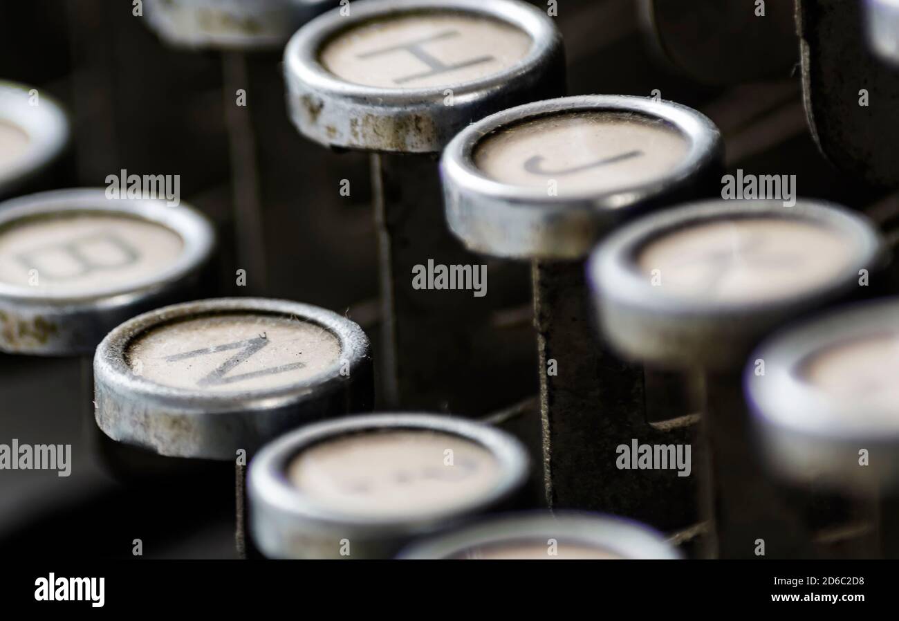 primo piano dei tasti polverosi di una vecchia macchina da scrivere. Profondità di campo poco profonda e messa a fuoco selettiva. Strumento di scrittura meccanico utilizzato in passato da scrittori e j Foto Stock