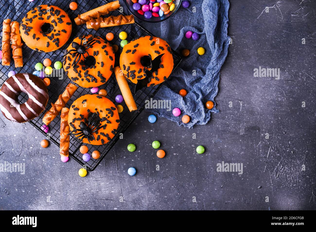 Ciambelle di Halloween su uno sfondo grigio di pietra. Dolci dolci decorati per una festa horror. Spazio di copia. Vista dall'alto. Foto di alta qualità. Foto di alta qualità Foto Stock