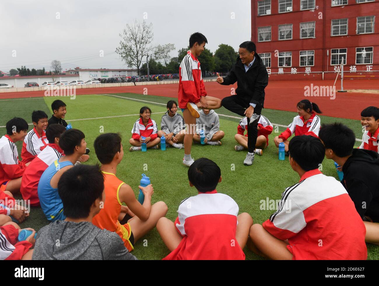 (201016) -- LUXI, 16 ottobre 2020 (Xinhua) -- Luo Laijin (R) gioca con i suoi studenti durante una lezione di formazione a scuola nella contea di Luxi, nella provincia di Jiangxi della Cina orientale, 15 ottobre 2020. Il 58-year-old Luo Laijin della scuola media della città di Yinhe della contea di Luxi sta lavorando come insegnante del P.E. dal 1982. Anche se si sta avvicinando al pensionamento, il suo zelo e meticolosità per l'educazione atletica non cambia mai. Sotto le sue istruzioni, i suoi studenti hanno vinto un totale di 1,600 premi in eventi sportivi di diversi livelli nel corso degli anni, e circa 180 studenti con specialità atletiche sono stati reclutati Foto Stock
