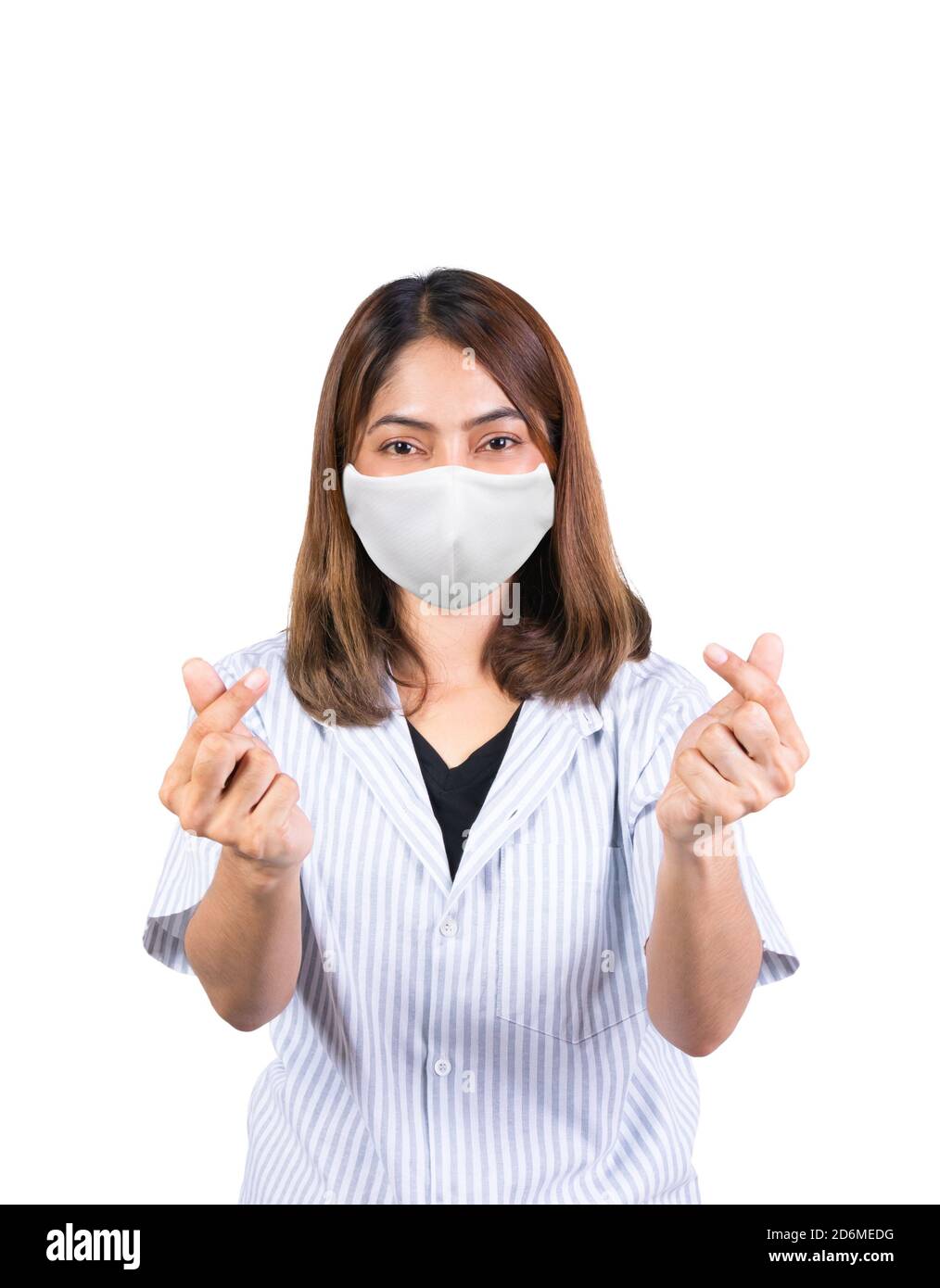 donna che mostra il mini segno del cuore e indossa la maschera di sicurezza in tessuto Covid-19 o coronavirus su sfondo bianco Foto Stock