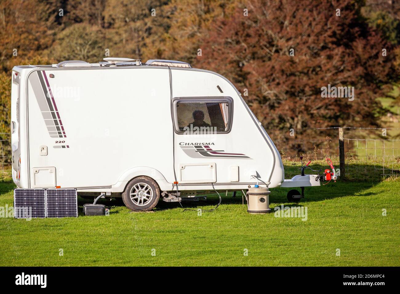 Caravan piccolo usando i pannelli solari per fornire l'elettricità su un sito senza collegamento Foto Stock