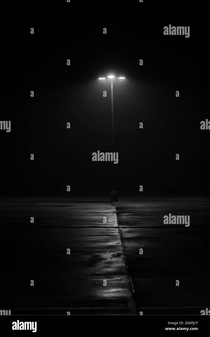 Lampada da strada su notte nebbia. Film noir feel con un senso di mistero e intrighi e texture oscure sulla terra. Immagine minimalista con spazio per la copia. Foto Stock