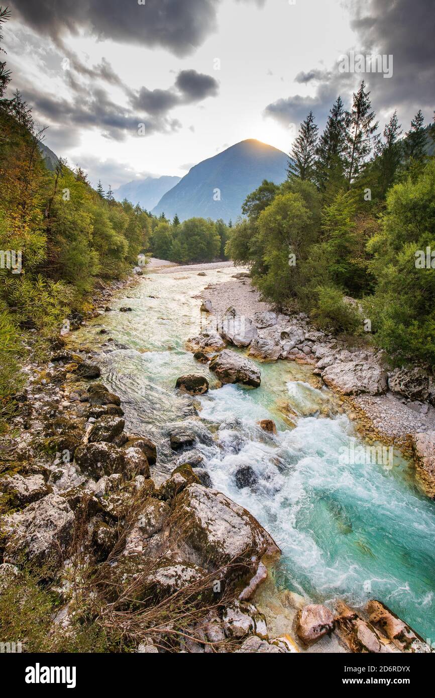 fiume soca con riva rocciosa e montagna sullo sfondo Foto Stock
