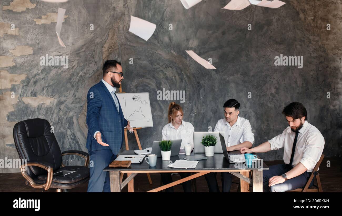 Arrabbiato boss rimprovero dipendente per il cattivo lavoro risultato seduto al tavolo della conferenza, uomo ceo scolding incompetente manager incolpando per errore in Foto Stock