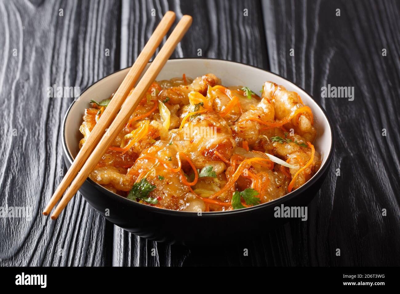 Delizioso maiale fritto Guo Bao Rou in salsa dolce e affumosa primo piano in una ciotola sul tavolo. Orizzontale Foto Stock