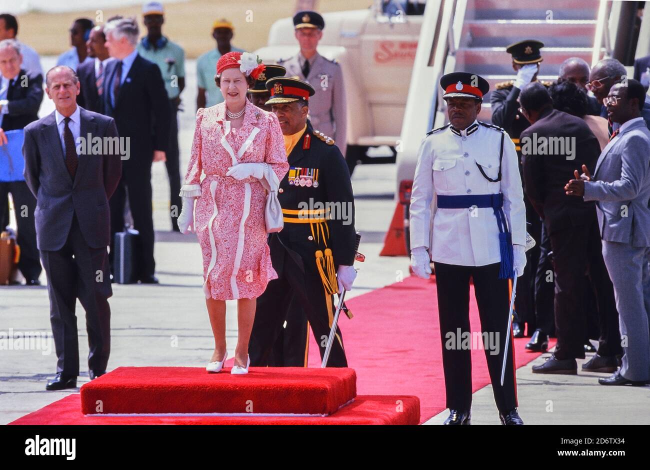 La regina Elisabetta II si erge sul tappeto rosso con una festa di dignitari prima della sua partenza all'aeroporto internazionale Grantley Adams, Barbados, dopo un tour reale dall'8 all'11 marzo 1989 Foto Stock