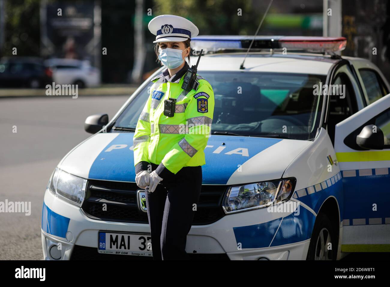 Bucarest, Romania - 18 ottobre 2020: L'ufficiale di polizia femminile tira sopra le automobili nel traffico per controllare se i conducenti rispettano le misure anticovidio. Foto Stock