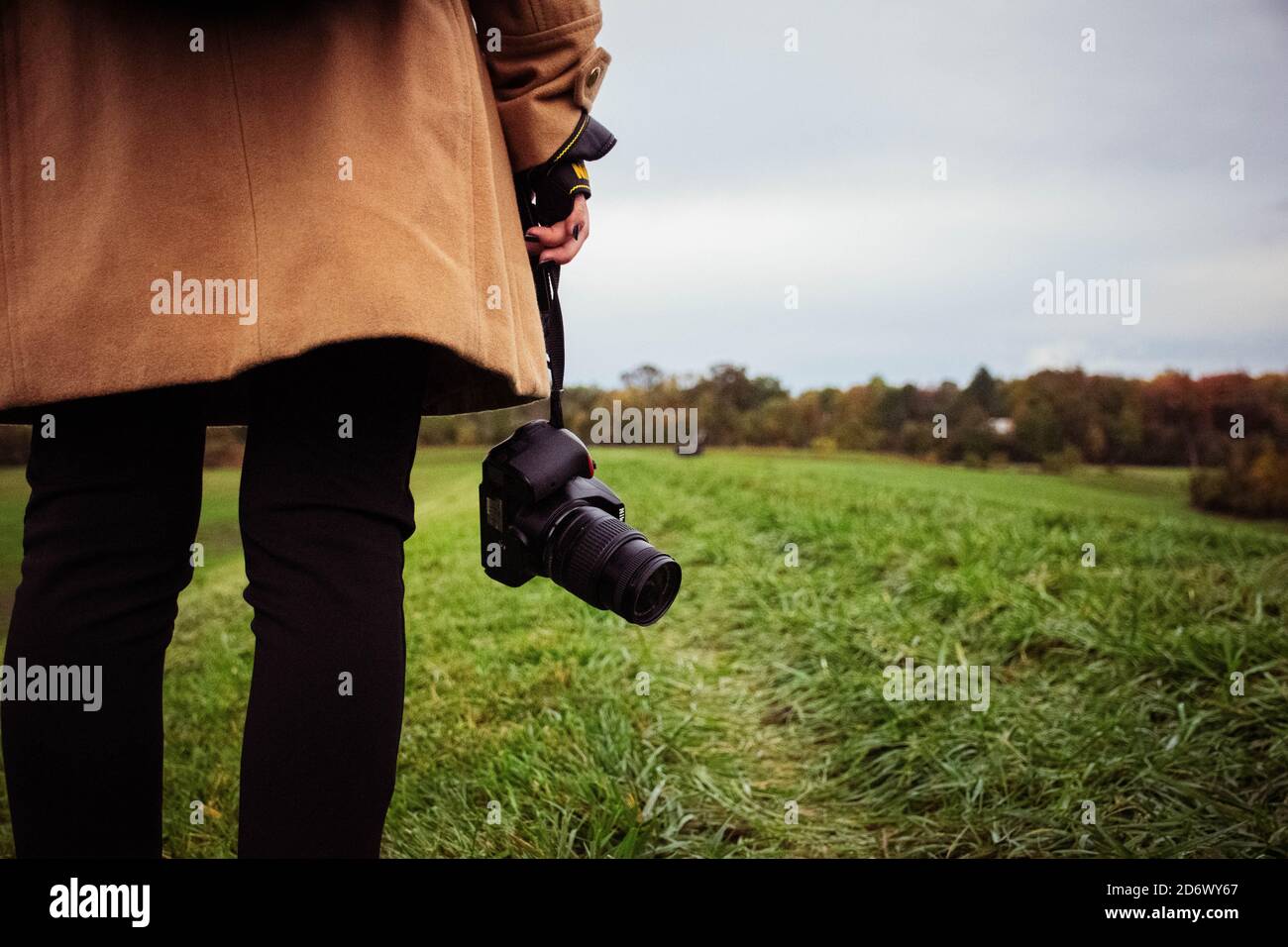 Persona che tiene la fotocamera nel parco Nike inferiore. Foto Stock