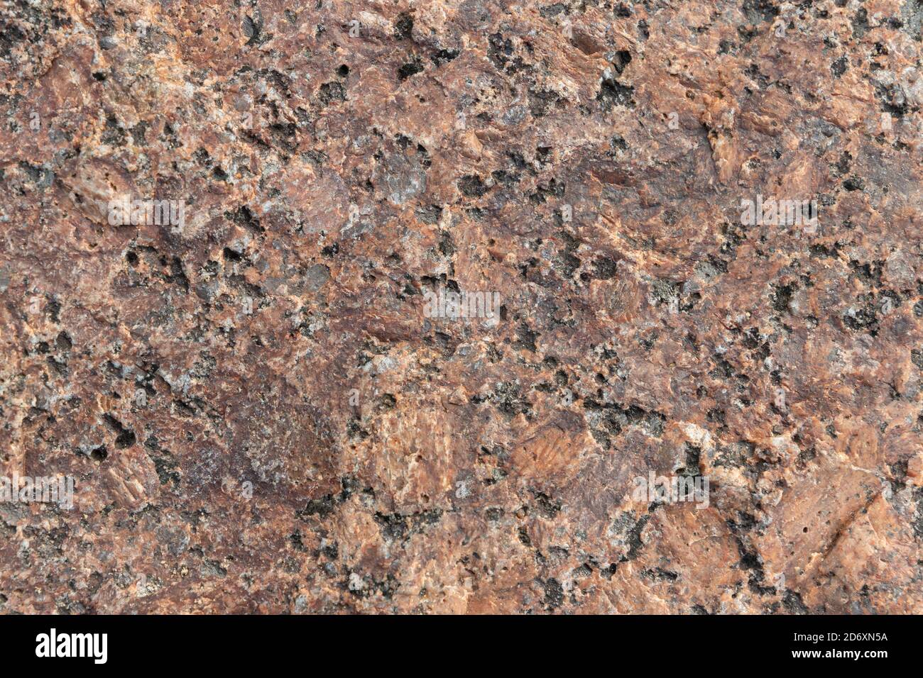 Superficie in pietra di granito marrone rosso naturale, trama foto di sfondo Foto Stock