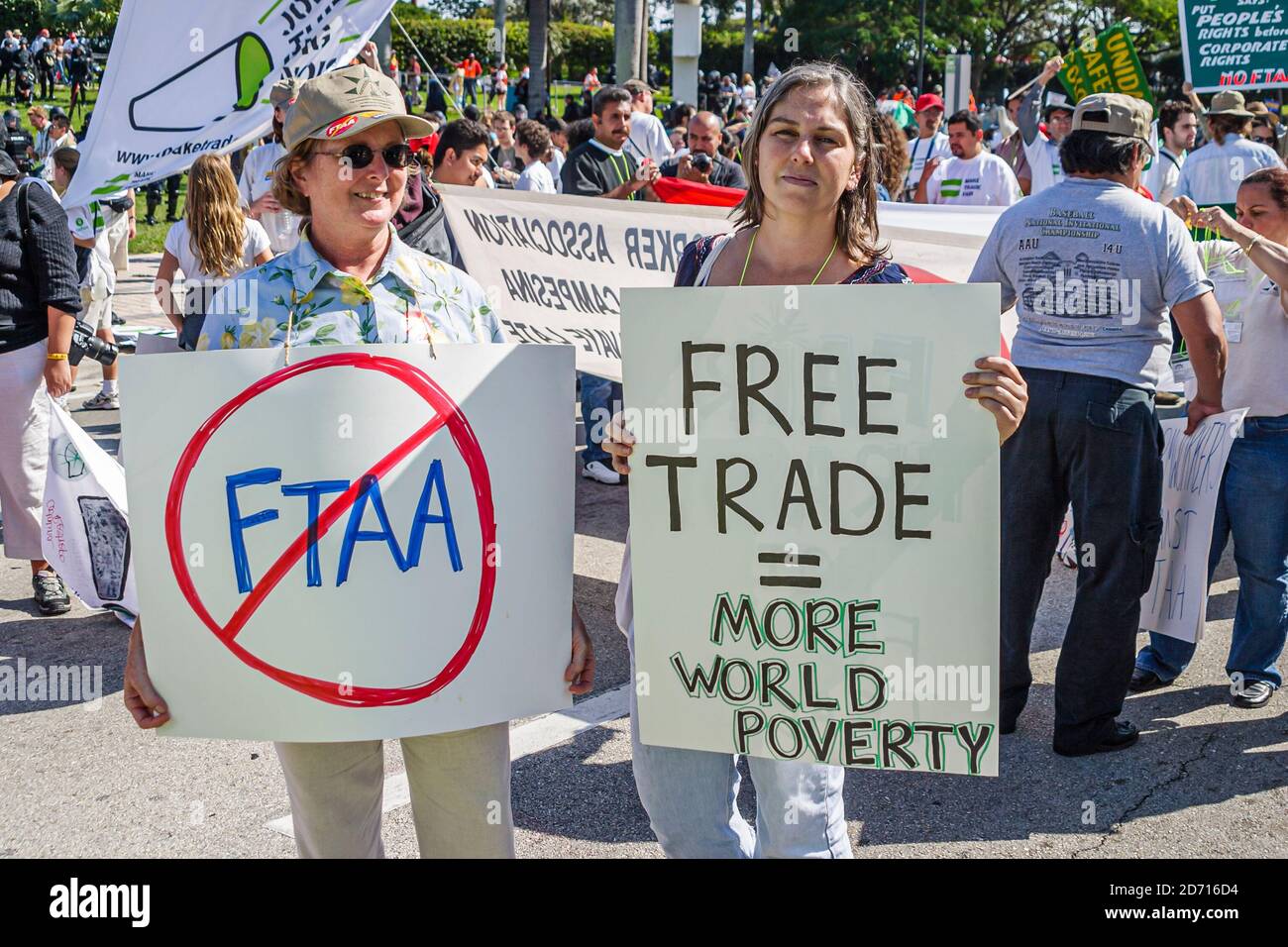 Miami Florida,Biscayne Boulevard,Free Trade Area of Americans Summit dimostrazioni FTAA,manifestante con banner in possesso manifesti povertà mondiale, Foto Stock