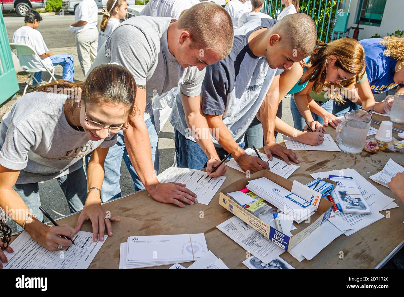 Miami Florida, Camillus House annuale pranzo del Ringraziamento povero senzatetto, volontari completare il questionario di sondaggio compilare, Foto Stock