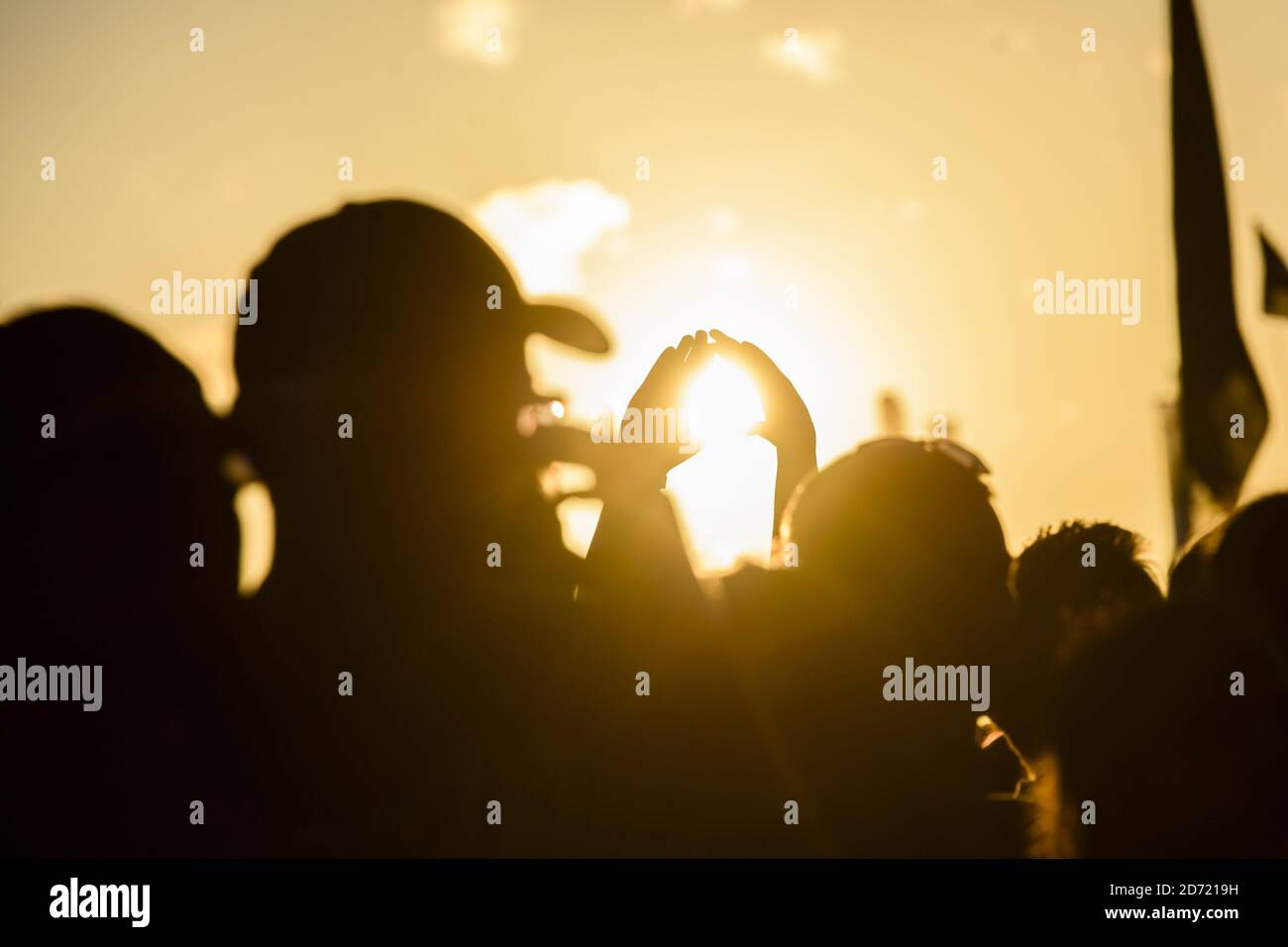 La folla guarda la Bastiglia che si esibisce al tramonto, sull'altro palco al Glastonbury Festival, presso la Worthy Farm di Somerset. Foto Stock