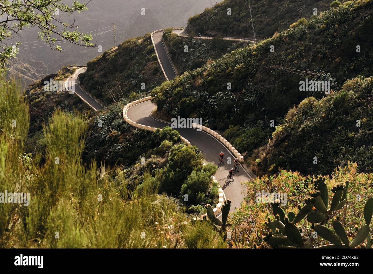 Vista retrocessa del gruppo ciclista sulla strada tortuosa a Masca, Tenerife Foto Stock