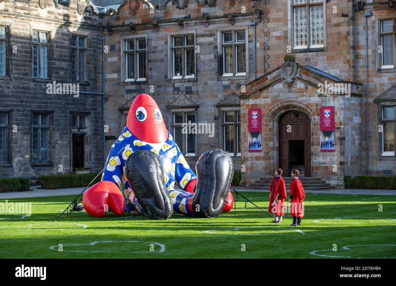 Gli studenti universitari James Knight (a sinistra) e Ignacio Ugalde dell'Università di St Andrews esamineranno da vicino Philip the Lobster in St Salvator's Quad, St Andrews. Foto Stock