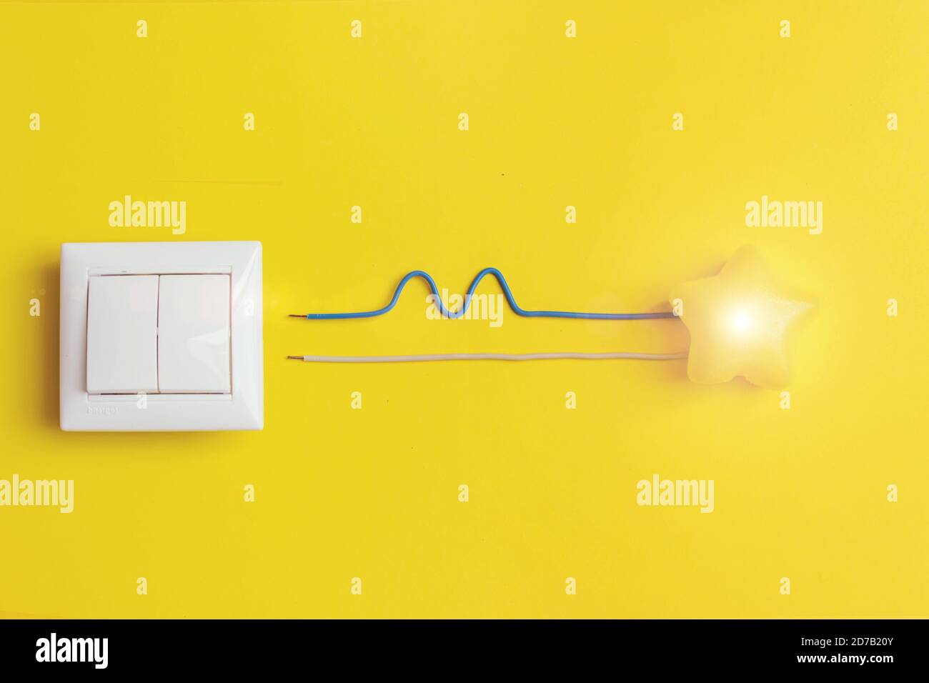 interruttore bianco e stella luminosa gialla con concetto di fase, zero, terra, unicità dei fili. Idea, innovazione, concetto di creatività Foto Stock