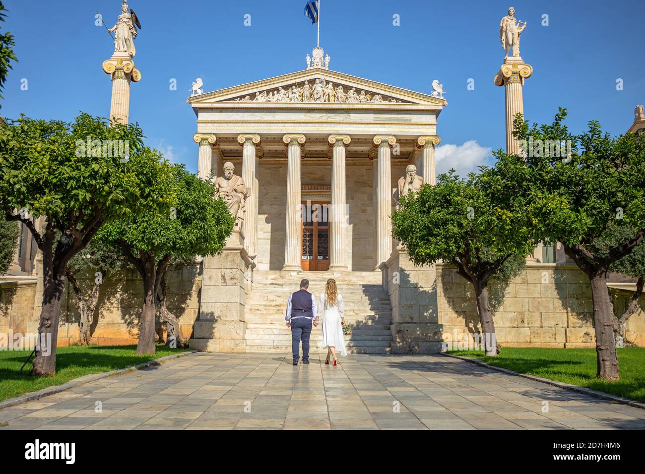 Bella coppia di nozze ad Atene, Grecia. Guarda l'architettura classica dell'Università, la vista dal retro Foto Stock