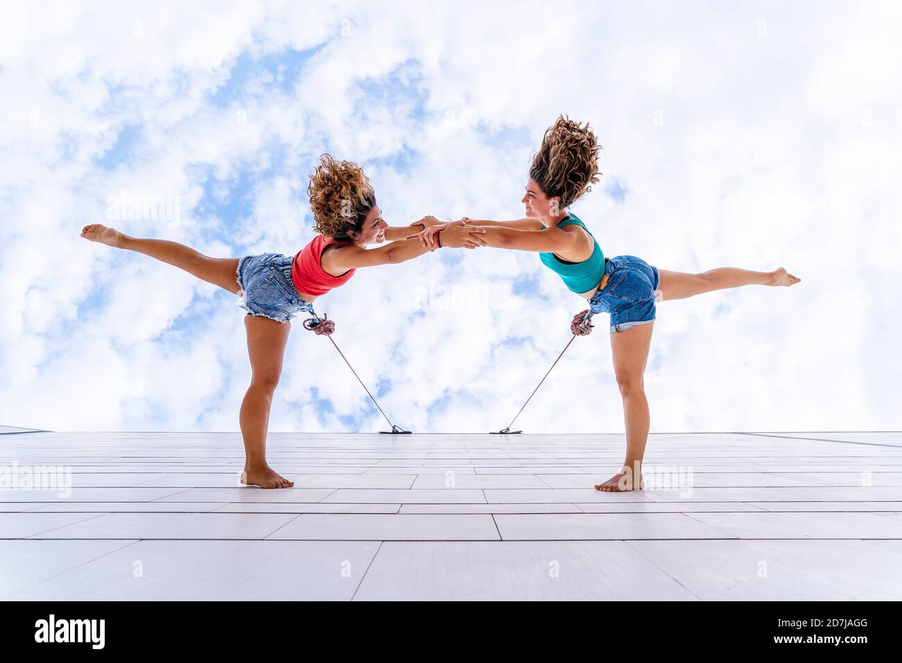 Ballerini aerei con capelli tondati che ballano contro il cielo sulla finestra Foto Stock