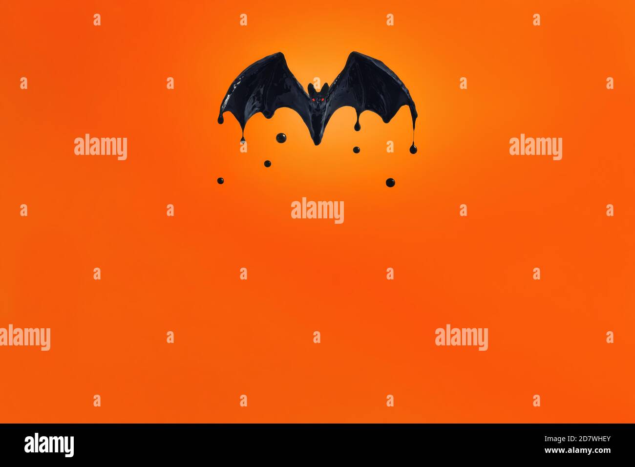 bat nero con occhi rossi su sfondo arancione. Foto Stock