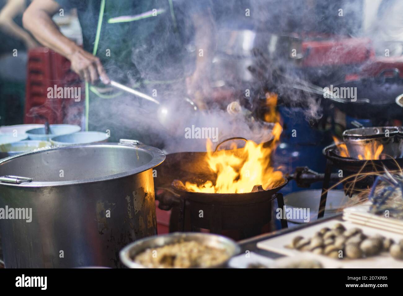 Cibo di strada a Bangkok Bangkok Thailandia - 24 ottobre 2020 :- cucina chef con fuoco con padella sul piano cottura a gas a yoawarat Bangkok Thailandia. Foto Stock