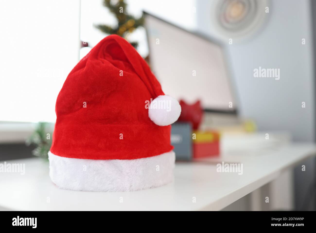 Sul desktop è un cappello rosso babbo natale con scatole regalo e computer  Foto stock - Alamy