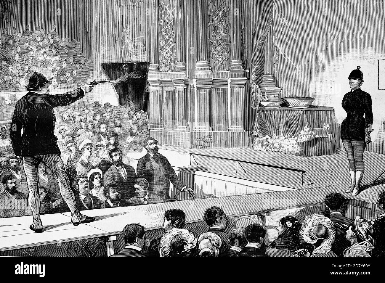 Madrid, Spagna, Circus Price, lo sparatutto americano MR. Paine che esegue le sue esercitazioni rischiose con sua moglie come assistente. Illustrazione antica. 1882. Foto Stock