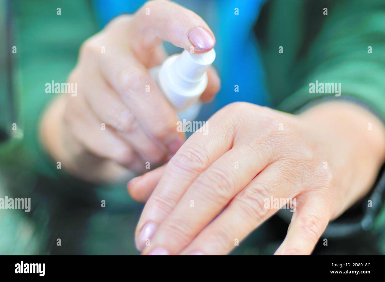 la mano tiene l'igienizzatore (antisettico) per la disinfezione antivirus e antibatterica Foto Stock