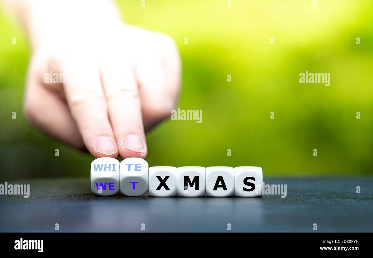 natale bianco o bagnato? La mano trasforma i dadi e cambia l'espressione 'wet xmas' in 'white xmas'. Foto Stock