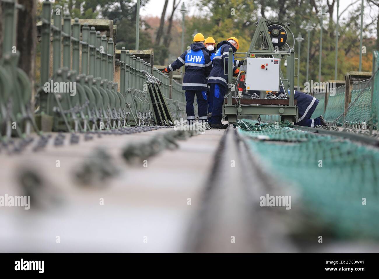 Pretzien, Germania. 26 Ottobre 2020. Il personale addetto alla protezione dalle inondazioni lavora sullo stregone durante l'evento '145 anni del Pretziener Weir'. La struttura lunga 163 metri serve la protezione dalle inondazioni delle città di Magdeburgo e Schönebeck. L'erede, costruito tra il 1871 e il 1875, ha il compito di equalizzare il livello dell'acqua dell'Elba. Credit: Peter Gercke/dpa-Zentralbild/ZB/dpa/Alamy Live News Foto Stock