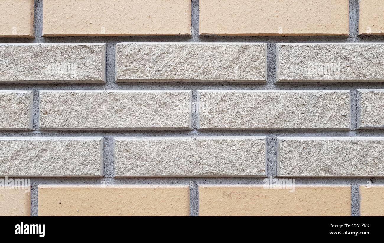 Due tipi di pareti rettangolari piastrellate in mattoni. Sfondo textured motivo mattone. Sfondo in muratura. Pietra muratura parete di superficie closeup Foto Stock