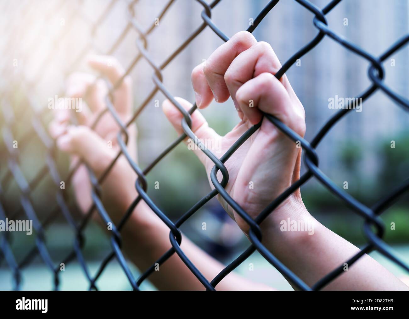 Concetto della Giornata internazionale dei diritti umani, le donne si impartano sulla recinzione a catena. Depressione, problemi e soluzione Foto Stock