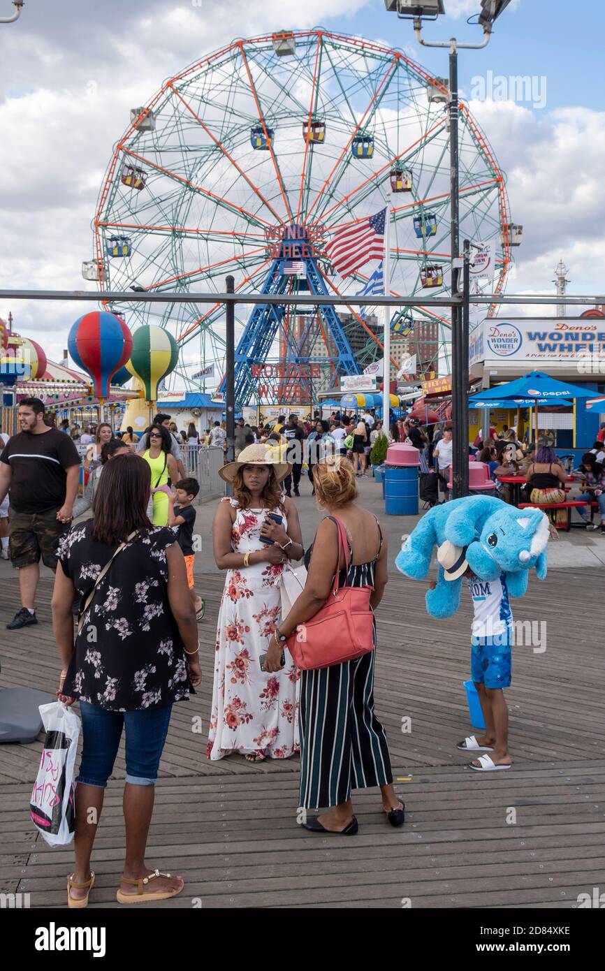 Gruppo di donne in piedi sul lungomare di fronte Wonder Wheel a Luna Park, Coney Island, Brooklyn, New York, USA Foto Stock