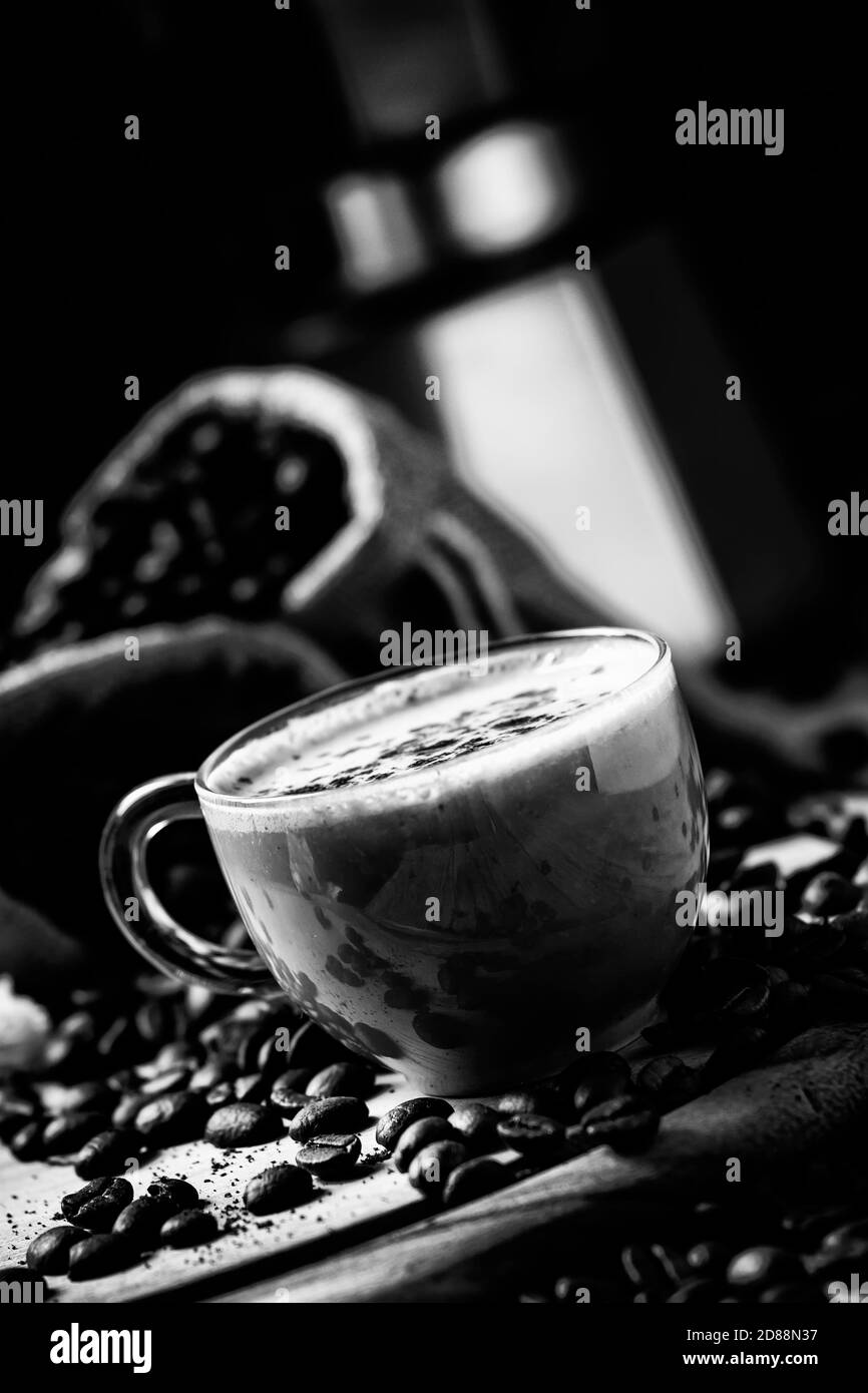 Caffè con latte, macchina per il caffè, chicchi di caffè, immagine dai toni scuri, messa a fuoco selettiva Foto Stock Caffè con latte, macchina per il caffè, chicchi di caffè, immagine dai toni scuri, messa a fuoco selettiva Foto Stock