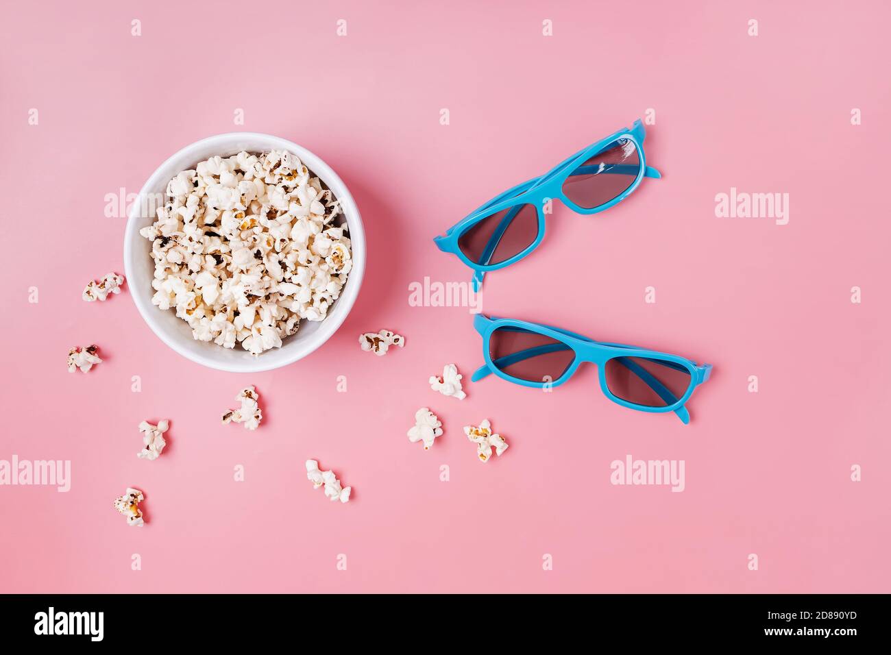 Ciotola di popcorn e bicchieri da cinema su sfondo rosa Foto Stock