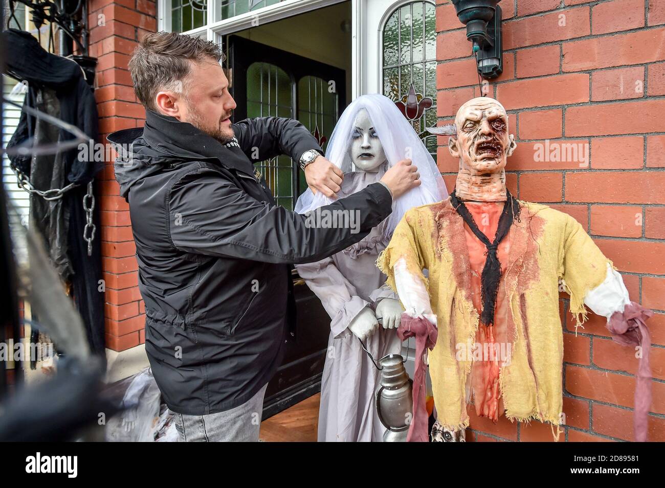Danny Hargreaves apre il velo di una figura spettrale nella sua casa di famiglia a Llandaff, vicino a Cardiff, che è decorato e adornato con decine di decorazioni realistiche di Halloween, installato da Danny, che lavora in TV effetti speciali. Foto Stock