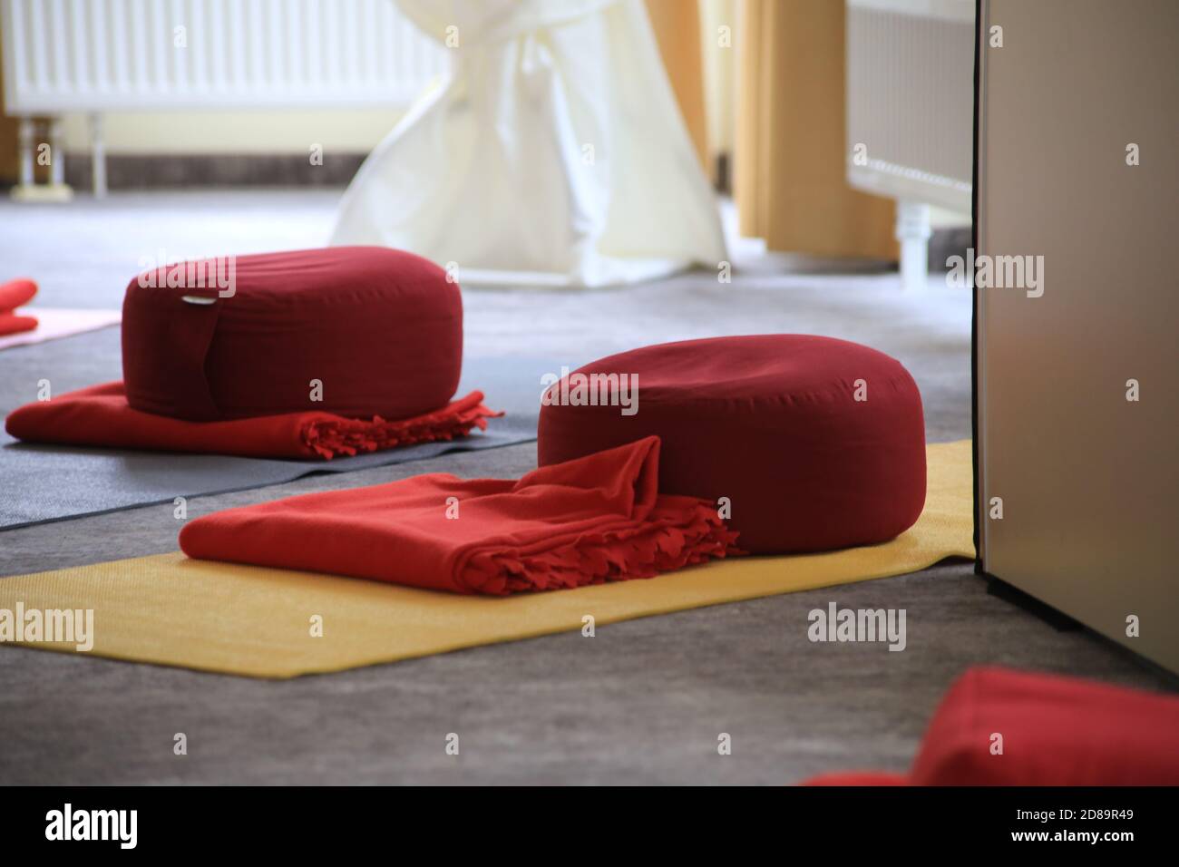 Sala yoga con tappetini e cuscini senza persone Foto Stock