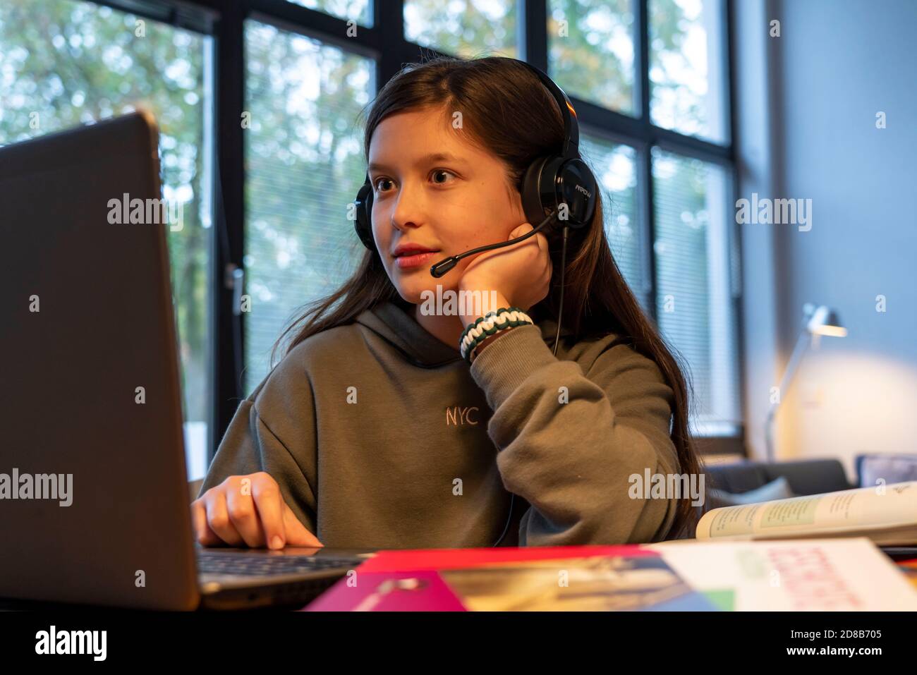 Homeschooling, ragazza, 11 anni, imparare a casa, imparare a casa, lezioni a casa, imparare a distanza, chattare con insegnanti e compagni di classe via laptop, Foto Stock