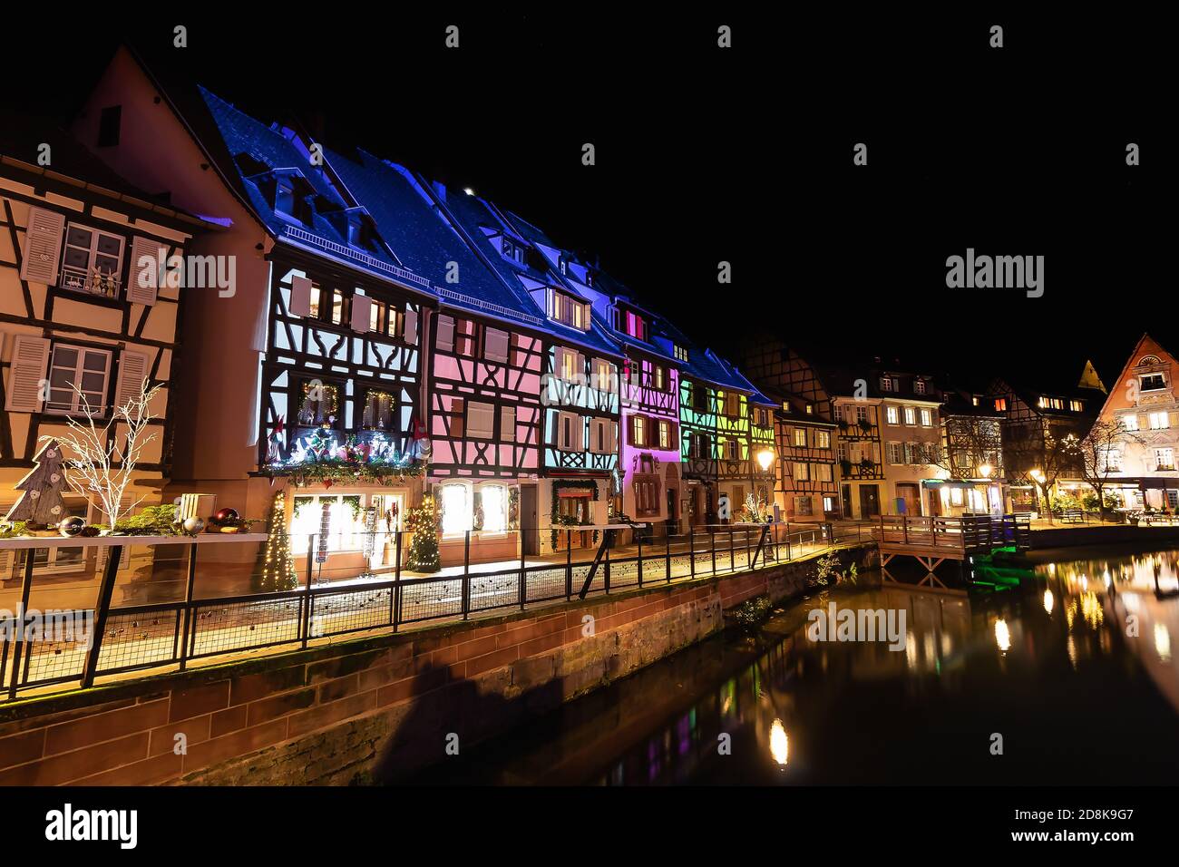 Tradizionale stile alsaziano semi-case con travi di legno e il fiume Lauch nella Petite Venise o piccola Venezia, la città vecchia di Colmar, decorata e illuminata di christma Foto Stock