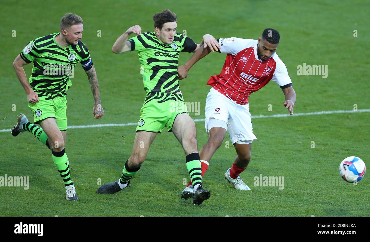 Reuben Reid (a destra) di Cheltenham Town e Liam Kitchen (al centro) di Forest Green Rover combattono per la palla durante la partita Sky Bet League due allo stadio Jonny-Rocks di Cheltenham. Foto Stock