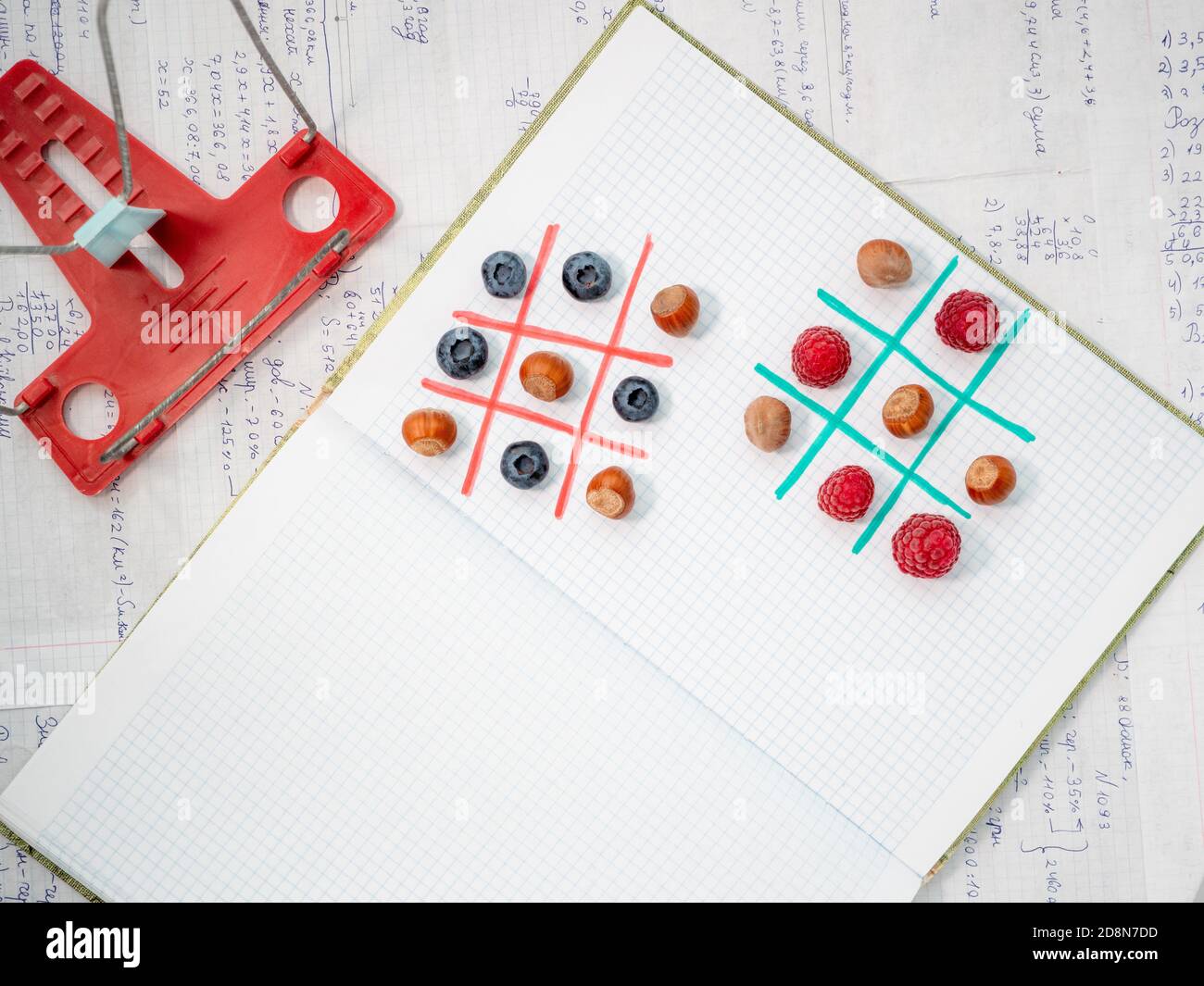 Apprendimento allegro senza noia mentre si gioca a giochi gustosi. Pausa pranzo con gli amici della scuola. Spazio per il testo. Studiare con divertimento. TIC-tac-TOE con bacca. Foto Stock