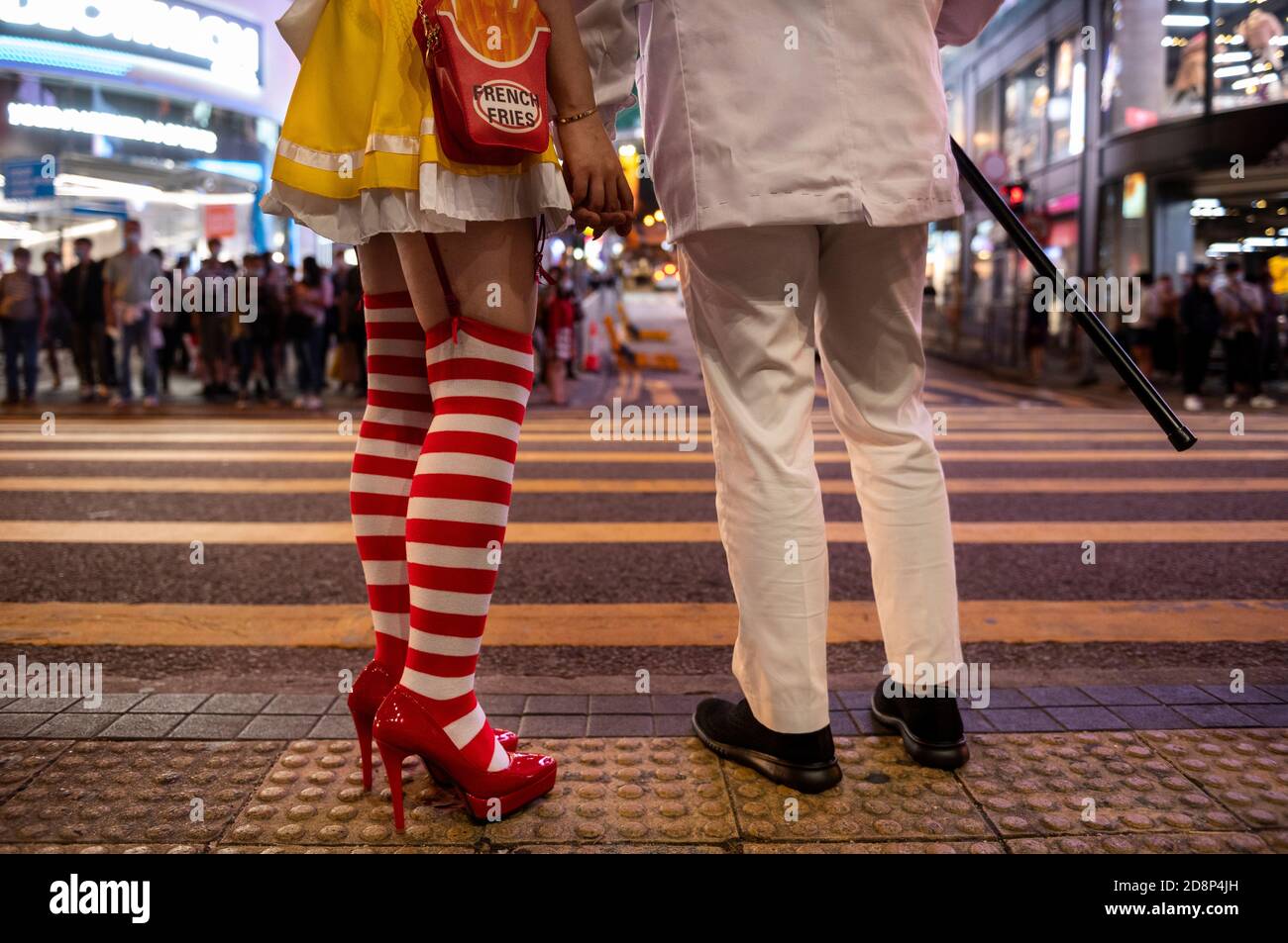 Una coppia vestita come Ronald McDonald e il colonnello Harland David Sander di KFC nella notte di Halloween a Hong Kong. Foto Stock